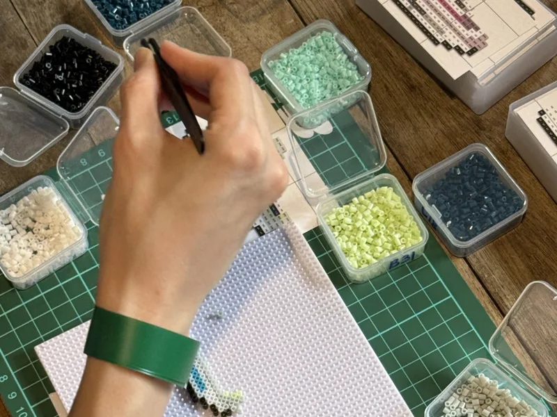 Placing fuse beads on a pegboard
